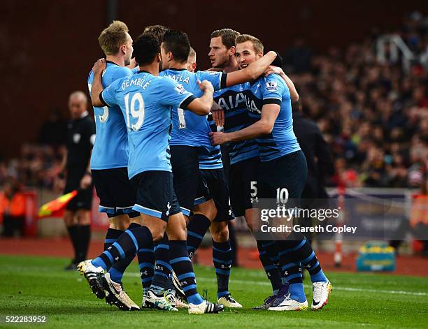 Harry Kane of Tottenham Hotspur celebrates with team mates as he scores their first goal during the Barclays Premier League match between Stoke City...