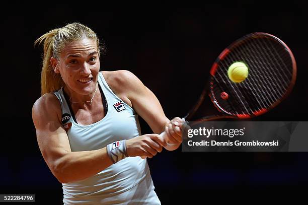 Timea Babos of Hungary plays a backhand in her match against Sabine Lisicki of Germany during Day 1 of the Porsche Tennis Grand Prix at Porsche-Arena...