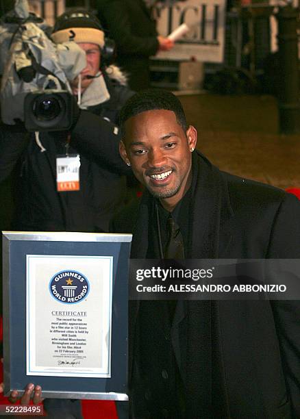 Will Smith arrives at the Odeon Cinema in Leicester Square for the UK premiere of the film "Hitch" in London, 22 February, 2005. Smith poses with his...