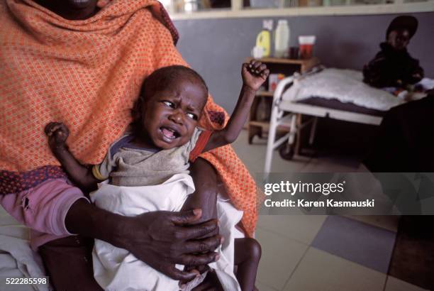 kenyan babies with malaria receiving quinine - kisumu stock pictures, royalty-free photos & images