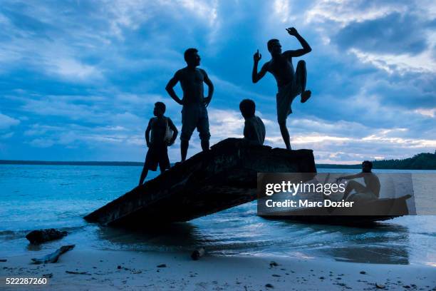 papuan men on an old bridge - papua new guinea people stock pictures, royalty-free photos & images