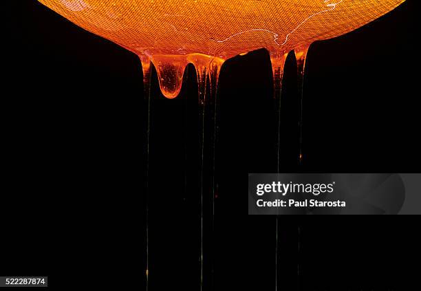 honey flowing from the sieve to bottom of honey ripener - sieve stock pictures, royalty-free photos & images