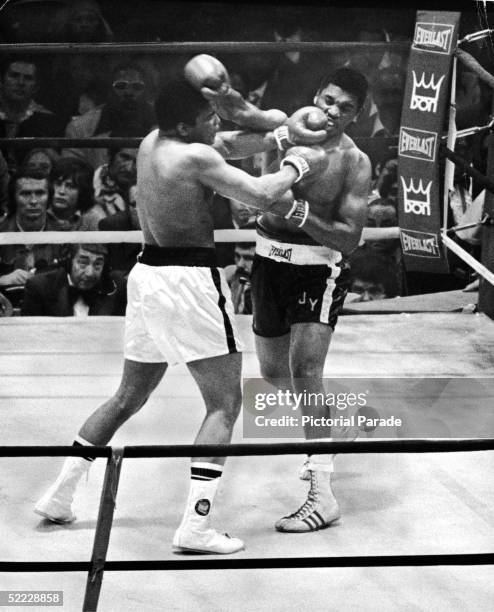 American professional boxers Muhammad Ali and Jimmy Young exchange blows during their championship bout for the world heavyweight title at the...