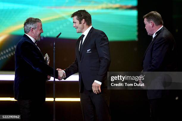 All Blacks Captain Richie McCaw is presented with the Laureus World Team of the Year trophy from Laureus World Sports Academy member Sean Fitzpatrick...