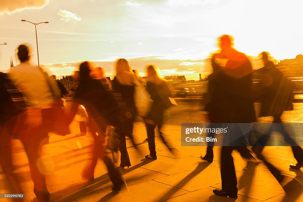 Large Group of Blurred Business People Rushing in Sunset Light