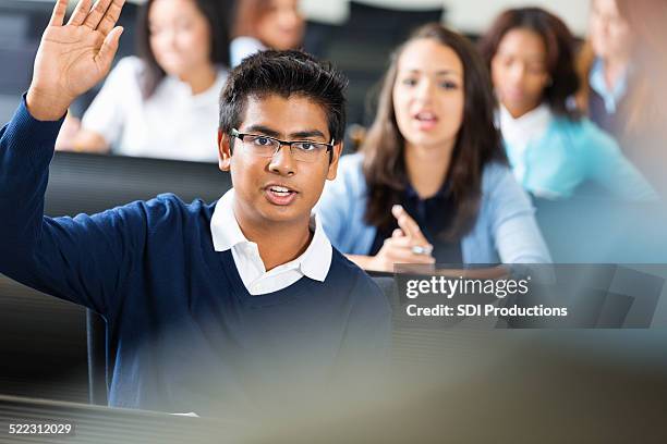 male student eager to answer a question in class - indian college stockfoto's en -beelden