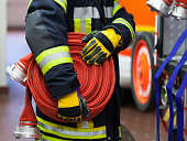 Firefighter wearing a rolled hose