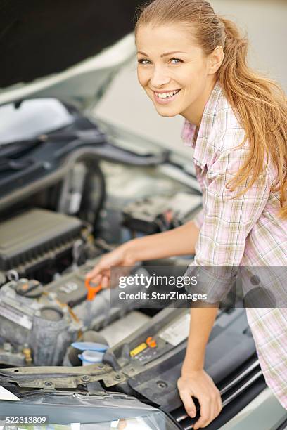 cute grease monkey by the roadside - dipstick stock pictures, royalty-free photos & images