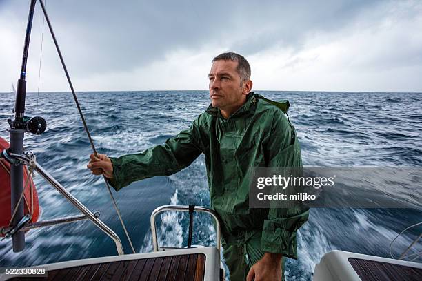 sailing on sailboat yacht - boat captain stockfoto's en -beelden