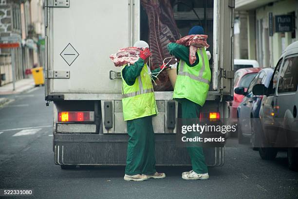 workers unloading meat delivery truck. - refrigerator truck stock pictures, royalty-free photos & images