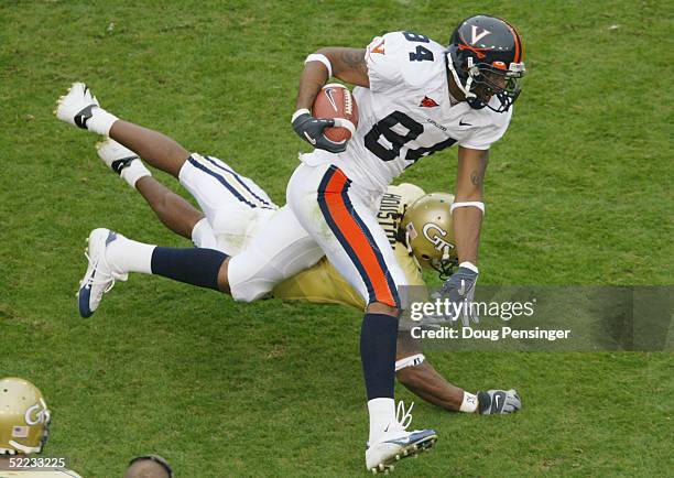 Wide receiver Fontel Mines of the University of Virginia Cavaliers rushes past cornerback Reuben Houston of the Georgia Tech Yellow Jackets during...