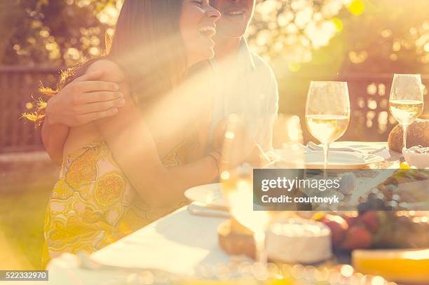 couple eating at an outdoor restaurant with friends. - picnic table stockfoto's en -beelden