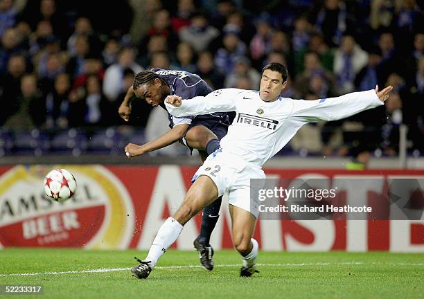 Ivan Ramiro Cordoba of Inter blocks a shot by Benni McCarthy of Porto during The UEFA Champions League knockout stage 1st leg match between Porto and...