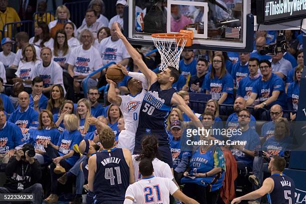 Russell Westbrook of the Oklahoma City Thunder tries to shoot over Salah Mejri of the Dallas Mavericks during the second half of Game One of the...