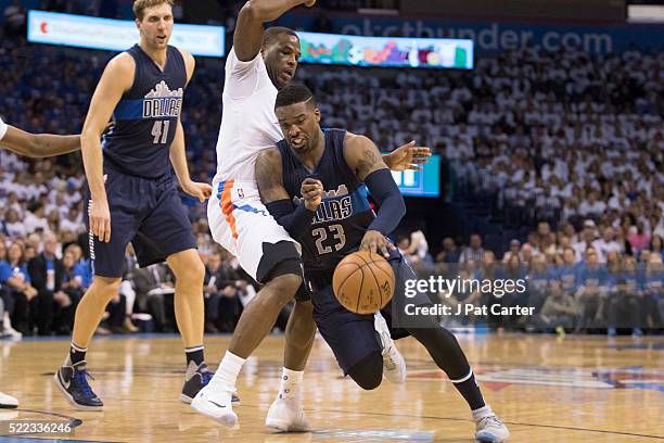 Wesley Matthews of the Dallas Mavericks drives around Dion Waiters of the Oklahoma City Thunder during the second half of Game One of the Western...