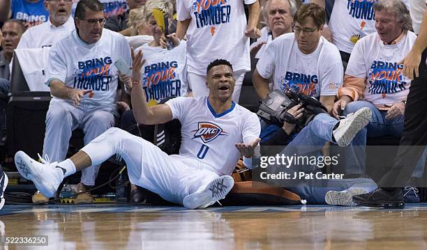 Russell Westbrook of the Oklahoma City Thunder reacts he was fouled by a Dallas Mavericks player during the second half of Game One of the Western...