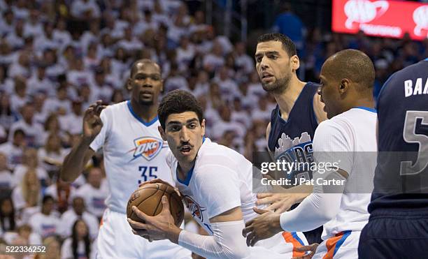 Enes Kanter of the Oklahoma City Thunder looks to drive around Salah Mejri of the Dallas Mavericks during the second half of Game One of the Western...