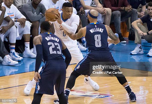 Wesley Matthews of the Dallas Mavericks and Deron Williams of the Dallas Mavericks apply pressure as Russell Westbrook of the Oklahoma City Thunder...