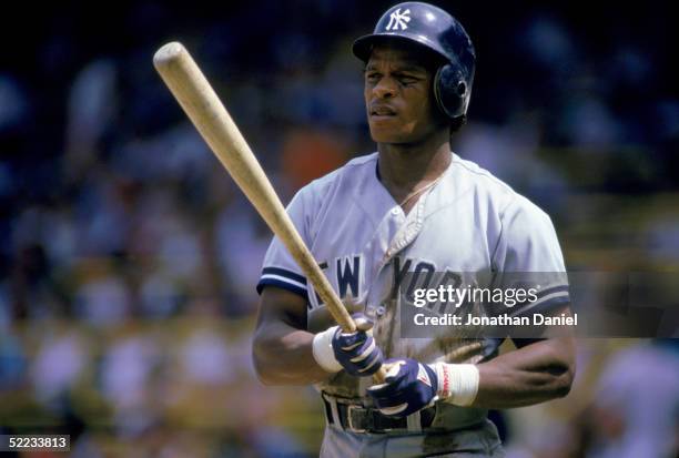 Rickey Henderson of the New York Yankees looks on as he prepares to bat during a game against the Chicago White Sox in 1987 at Comiskey Park in...