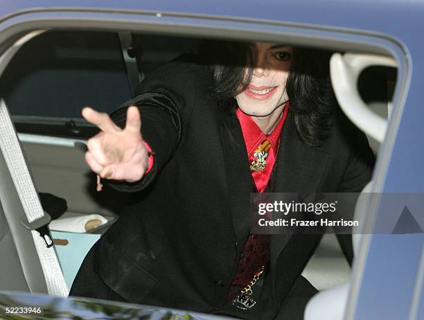 Musician Michael Jackson gestures from a vehicle as he departs the Santa Barbara County Courthouse during the jury selection phase of his child...