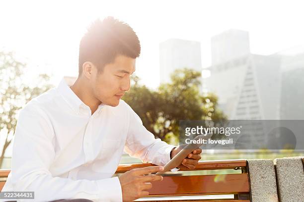 businessman using app on tablet outdoor for business report afte - afte stock pictures, royalty-free photos & images