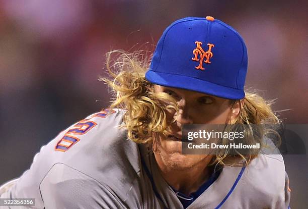 Noah Syndergaard of the New York Mets has his hair fly in his face while delivering a pitch in the seventh inning against the Philadelphia Phillies...