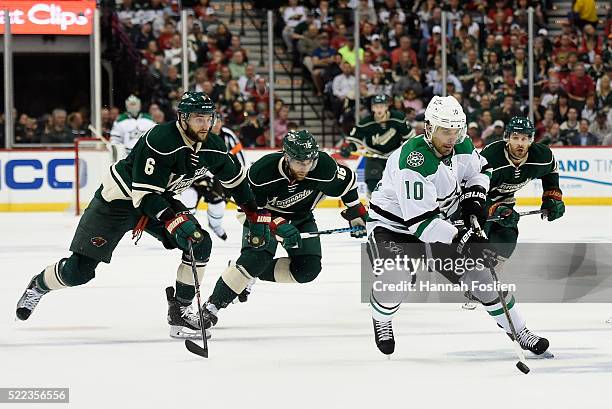 Patrick Sharp of the Dallas Stars breaks away from Marco Scandella, Jason Zucker and Justin Fontaine of the Minnesota Wild with the puck during the...