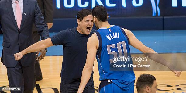 Mark Cuban owner of the Dallas Mavericks celebrates with Salah Mejri of the Dallas Mavericks after Game Two of the Western Conference Quarterfinals...