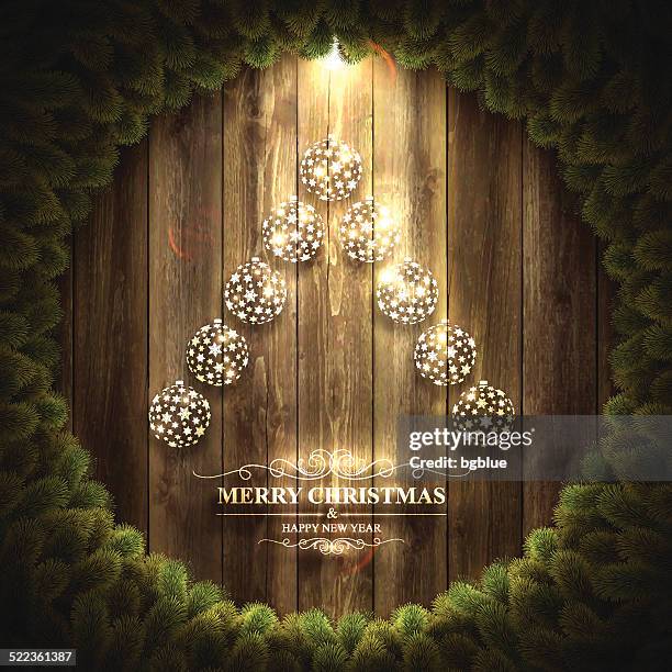 christmas tree with bright baubles on wooden background and wreath - tinsel wall stock illustrations