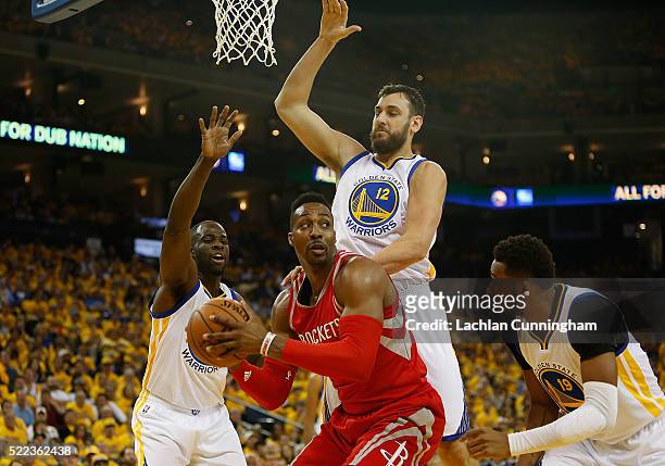 Dwight Howard of the Houston Rockets is guarded by Draymond Green, Andrew Bogut and Leandro Barbosa of the Golden State Warriors in the first quarter...