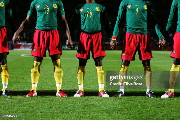 Cameroon players holds hands prior to the International friendly match between Cameron and Senegal at Stade Dominique Duvauchelle on February 8, 2005...