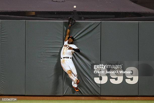 Denard Span of the San Francisco Giants leaps for but is unable to catch a fly ball hit for a home run by Welington Castillo of the Arizona...