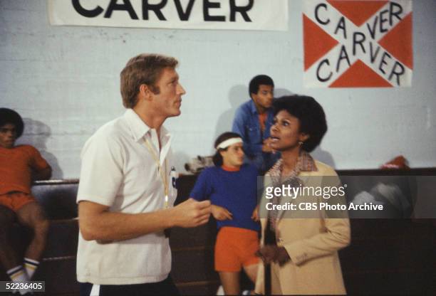 Still from the CBS dramatic television series 'The White Shadow' shows American actors Ken Howard and Joan Pringle as they talk on the sidelines of a...
