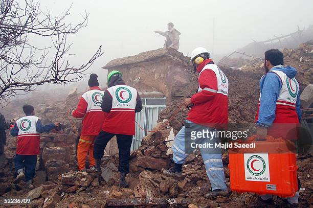 People search amid the rubble for survivors of the earthquake February 24, 2005 in the village of Oudkan, about 700 km southeast of the capital...