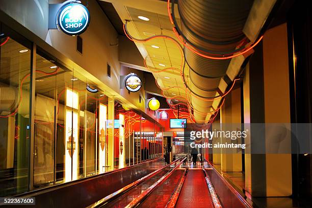 man on moving walkway at philadelphia airport - philadelphia airport stock pictures, royalty-free photos & images