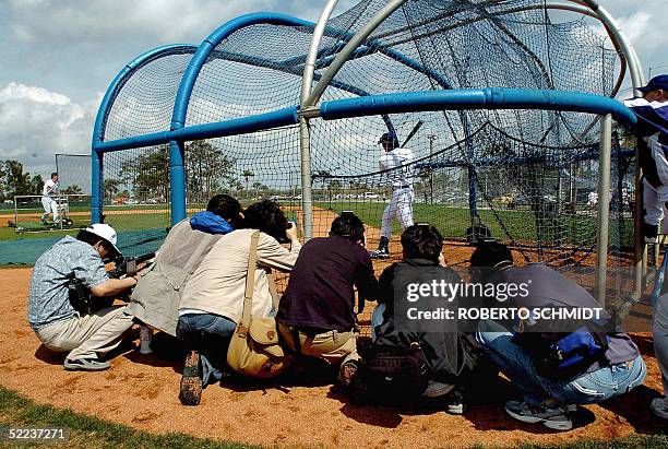 Asian photographers crowd the side of a batting cage with their focus on Los Angeles Dodgers infielder Hee-Seop Choi of South Korea during a practice...