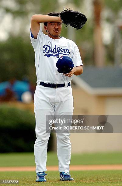 Los Angeles Dodgers pitcher Kazahusi Ishii wipes his brow during a practice session at team's Spring Training center in Vero Beach, Florida, 24...