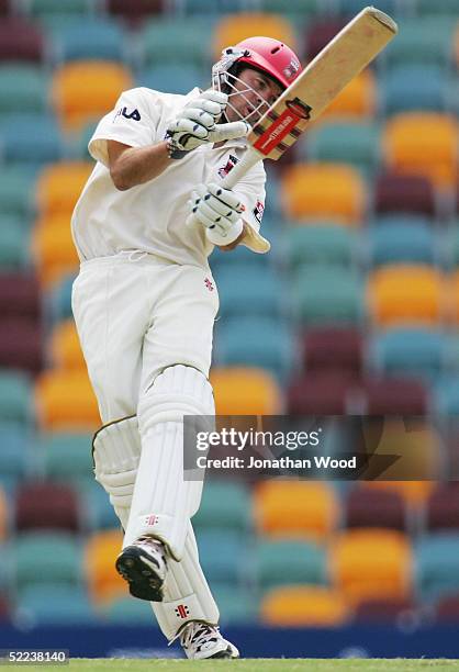 Greg Blewett of the Redbacks avoids a delivery from Joe Dawes of the Bulls during day 2 of the Pura Cup match between the Queensland Bulls and South...