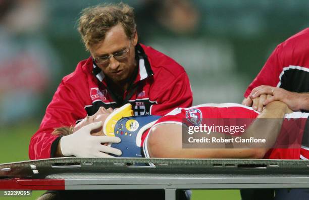 Max Hudghton of the Saints is taken from the ground with an injury after colliding with Chris Grant of the Bulldogs during the quarter final Wizard...