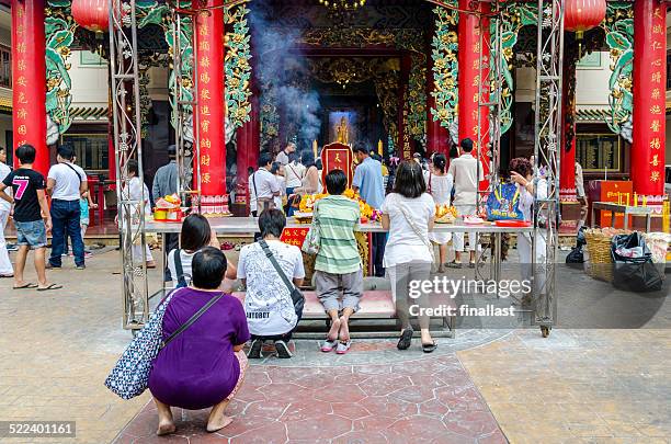 people pray inside guanyin temple at china town - shrine stock pictures, royalty-free photos & images
