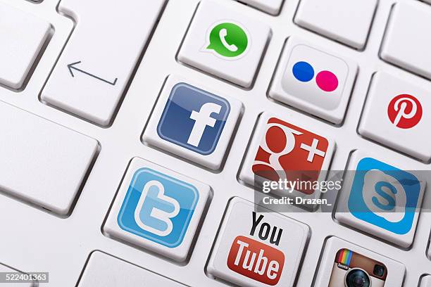 social networking - facebook, twitter, instagram logos on keyboard menu - google social networking service stock pictures, royalty-free photos & images