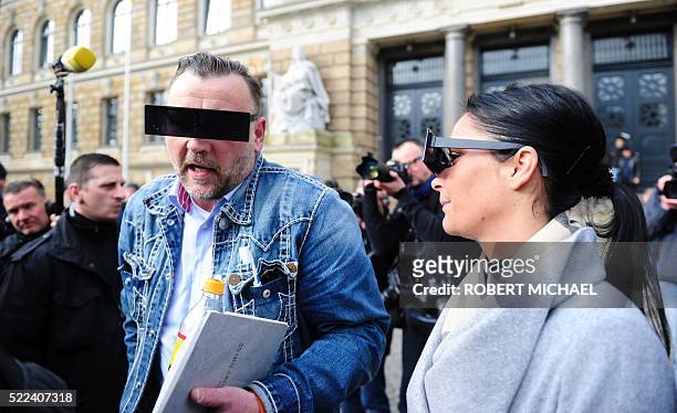Lutz Bachmann , founder of Germany's xenophobic and anti-Islamic PEGIDA movement , and his wife Vicky Bachmann have their eyes covered as if...