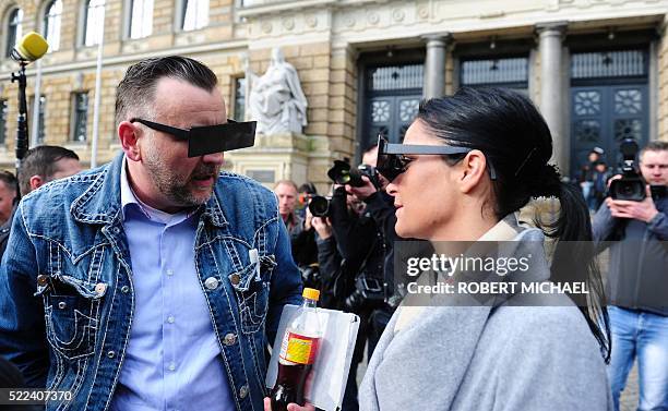 Lutz Bachmann , founder of Germany's xenophobic and anti-Islamic PEGIDA movement , and his wife Vicky Bachmann have their eyes covered as if...