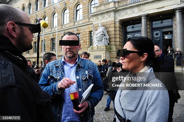 Lutz Bachmann , founder of Germany's xenophobic and anti-Islamic PEGIDA movement , and his wife Vicky Bachmann have their eyes covered as if...