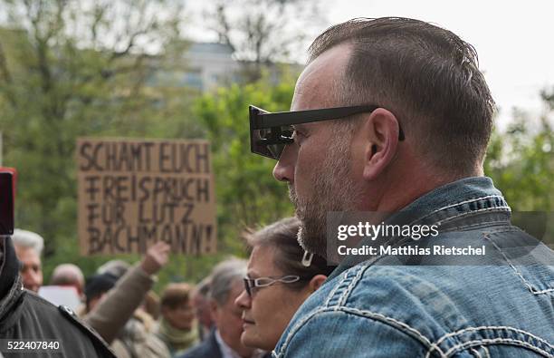 Lutz Bachmann, wearing black glasses, founder of the Pegida movement, surrounded by supporter, arrives for the first day of his trial to face charges...