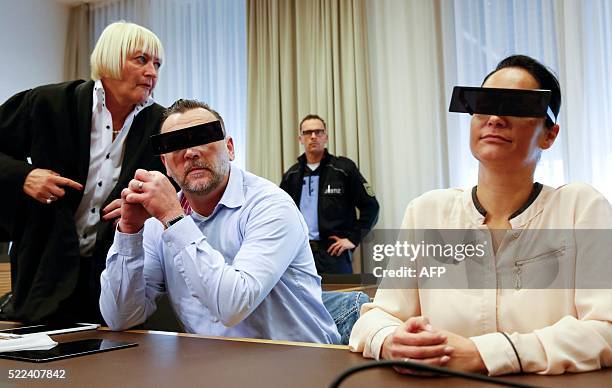 Lutz Bachmann , founder of Germany's xenophobic and anti-Islamic PEGIDA movement , has his eyes covered as if pixelized by media as he sits next to...