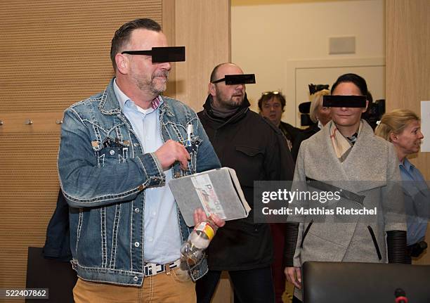 Lutz Bachmann, wearing black glasses, founder of the Pegida movement, and his wife Vicky, right, arrive for the first day of his trial to face...