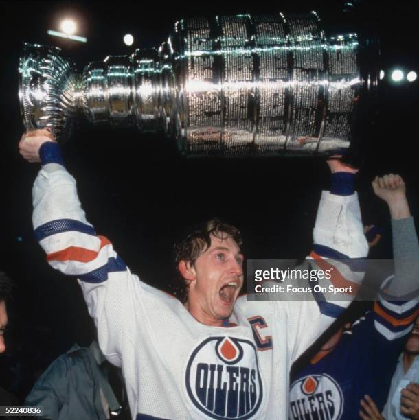 Edmonton Oilers' Wayne Gretzky holds up the Stanley Cup after a defeating the New York Islanders at the Northlands Coliseum on May 19, 1984 in...