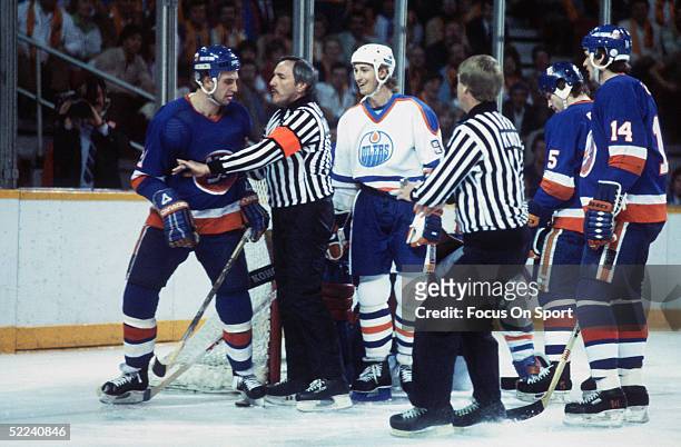 Edmonton Oilers' Wayne Gretzky smiles to taunt the New York Islanders' center Brent Sutter after scoring during a game at the Northlands Coliseum...
