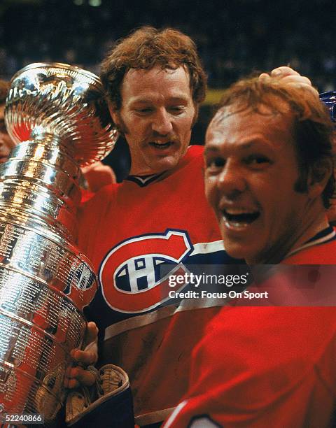 Larry Robinson and Yvan Cournoyer of the Montreal Canadiens celebrate with the Stanley Cup Trophy after defeating the Boston Bruins for the 1978...